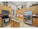Bright kitchen features granite counters, stainless appliances, breakfast bar, and large refrigerator at 6104 Cognac Cir, Lutz, FL 33558