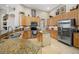Bright kitchen features granite counters, tile backsplash, stainless appliances, and a functional island at 6104 Cognac Cir, Lutz, FL 33558