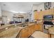 Open eat-in kitchen features granite countertops and stainless steel appliances, with a breakfast bar at 6104 Cognac Cir, Lutz, FL 33558