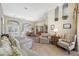 Bright living room with hardwood floors, neutral paint, and lots of natural light from large windows at 6104 Cognac Cir, Lutz, FL 33558