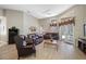 Bright living room features high ceilings, a ceiling fan, and view to the pool at 6104 Cognac Cir, Lutz, FL 33558