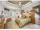 A primary bedroom features a ceiling fan, wood floors, and built in wardrobes at 6104 Cognac Cir, Lutz, FL 33558