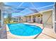 Inviting in-ground pool in a screened enclosure with a brick-paved patio at 6104 Cognac Cir, Lutz, FL 33558