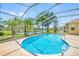 Beautiful in-ground pool enclosed with a screen, surrounded by a brick-paved patio at 6104 Cognac Cir, Lutz, FL 33558