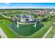 Aerial view of Talon Preserve on Palmer Ranch entrance featuring a water feature, lush landscaping, and community signage at 6137 Wire Grass Ct, Nokomis, FL 34275