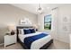 Inviting bedroom with a plush bed, decorative pillows, and a large window offering natural light and a view at 6137 Wire Grass Ct, Nokomis, FL 34275
