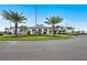 Beautiful clubhouse surrounded by palm trees and meticulous landscaping, providing an inviting space for community gatherings at 6137 Wire Grass Ct, Nokomis, FL 34275