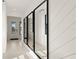 Elegant foyer with decorative mirrors and a view of the entrance creates a welcoming and sophisticated entry at 6137 Wire Grass Ct, Nokomis, FL 34275