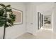 Bright hallway with decorative accents and a view of the living area creates a welcoming and stylish entrance at 6137 Wire Grass Ct, Nokomis, FL 34275
