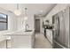 Contemporary kitchen with white cabinetry, stainless steel appliances, and a quartz-topped island at 6137 Wire Grass Ct, Nokomis, FL 34275
