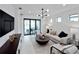 Cozy living room featuring stylish furnishings and a view of the outdoor patio is perfect for relaxing and entertaining at 6137 Wire Grass Ct, Nokomis, FL 34275