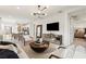 Bright, open living room with modern lighting, dining area, and open kitchen offers a stylish and comfortable space at 6137 Wire Grass Ct, Nokomis, FL 34275