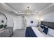 Bright main bedroom with a decorative ceiling, elegant chandelier, and ensuite bathroom offers a luxurious and private space at 6137 Wire Grass Ct, Nokomis, FL 34275