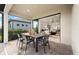 Covered patio with outdoor seating and a seamless transition to the home's interior through sliding glass doors at 6137 Wire Grass Ct, Nokomis, FL 34275