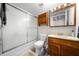 Bathroom featuring a tub and shower, wooden vanity, and wooden medicine cabinet at 710 N Village N Dr # 102, St Petersburg, FL 33716