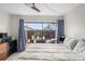 Comfortable bedroom featuring a sliding glass door to the outdoors and a ceiling fan at 710 N Village N Dr # 102, St Petersburg, FL 33716
