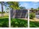 Exterior view of the Village Lake Condominiums entrance sign on a sunny day at 710 N Village N Dr # 102, St Petersburg, FL 33716