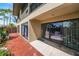 Exterior view of the back of the home and patio featuring sliding glass doors at 710 N Village N Dr # 102, St Petersburg, FL 33716
