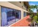 Back exterior of the property showing a brick patio and sliding glass doors at 710 N Village N Dr # 102, St Petersburg, FL 33716