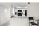 Kitchen features white cabinets, a gray countertop, and sleek, black appliances at 710 N Village N Dr # 102, St Petersburg, FL 33716