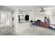 Open living space with kitchen view featuring white cabinets and breakfast bar seating at 710 N Village N Dr # 102, St Petersburg, FL 33716