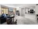 Bright living room featuring carpet floors, updated kitchen, and large window at 710 N Village N Dr # 102, St Petersburg, FL 33716