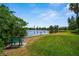 Scenic view of the pond, featuring a park bench overlooking the water at 710 N Village N Dr # 102, St Petersburg, FL 33716