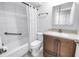 Bright bathroom with white tiled walls, updated vanity, and shower-tub combination at 7242 55Th N Ave, St Petersburg, FL 33709