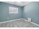 Bedroom with tile floors, blue walls, and a window letting in natural light at 7242 55Th N Ave, St Petersburg, FL 33709