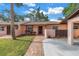 Charming single-story home with a manicured lawn and a brick pathway leading to the front door at 7242 55Th N Ave, St Petersburg, FL 33709