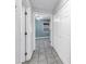 Hallway showcases neutral paint, tiled floor, and multiple closets for ample storage at 7242 55Th N Ave, St Petersburg, FL 33709