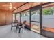 Relaxing screened lanai with ceiling fan, two chairs, and outdoor view at 7242 55Th N Ave, St Petersburg, FL 33709