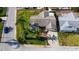 An overhead view shows a quaint single-Gathering home with mature landscaping, a driveway, and a nearby street at 7534 Culberson Dr, Port Richey, FL 34668