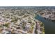 Expansive aerial view of a residential community nestled alongside a tranquil river, showcasing the neighborhood's serene setting at 7534 Culberson Dr, Port Richey, FL 34668