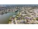 A picturesque residential area hugs the curve of a serene lake, showcasing rows of neatly arranged homes at 7534 Culberson Dr, Port Richey, FL 34668
