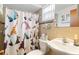 Cozy bathroom featuring a playful shower curtain and tile-look walls at 7534 Culberson Dr, Port Richey, FL 34668