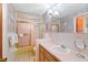 Bathroom featuring a tub/shower combination, vanity with sink, and a large mirror at 7534 Culberson Dr, Port Richey, FL 34668