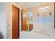 Bathroom features floral wallpaper, a vanity with an integrated sink, and fixtures with views into the toilet and shower area at 7534 Culberson Dr, Port Richey, FL 34668