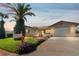 Charming home with a green lawn, mature trees, and a well-maintained landscape at dusk at 7534 Culberson Dr, Port Richey, FL 34668