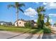 View of home with mature trees, green lawn and shrubs on a corner lot at 7534 Culberson Dr, Port Richey, FL 34668