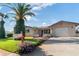 Charming home with a green lawn, mature trees, and a well-maintained landscape at 7534 Culberson Dr, Port Richey, FL 34668
