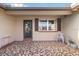 Charming front porch with decorative tiled floor, a small chair, and a storm door at 7534 Culberson Dr, Port Richey, FL 34668