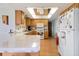 A light-filled kitchen with wood cabinets, white appliances, and tile countertops at 7534 Culberson Dr, Port Richey, FL 34668