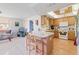 A kitchen with a breakfast bar overlooking a living area filled with natural light at 7534 Culberson Dr, Port Richey, FL 34668