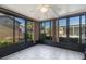 Bright sunroom with tiled floor, large windows, and serene outdoor views at 7534 Culberson Dr, Port Richey, FL 34668