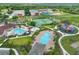 An aerial shot displays community amenities including pools, sports courts, playgrounds, and landscaping at 7649 Nottinghill Sky Dr, Apollo Beach, FL 33572