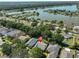 An aerial view of a home featuring a private pool, landscaped yard, and nearby lake access in a serene neighborhood at 7649 Nottinghill Sky Dr, Apollo Beach, FL 33572