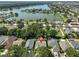 An aerial view of a home featuring a private pool, landscaped yard, and nearby lake access in a serene neighborhood at 7649 Nottinghill Sky Dr, Apollo Beach, FL 33572