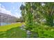 Lush backyard with stone path, pool, and screen enclosure at 7649 Nottinghill Sky Dr, Apollo Beach, FL 33572