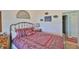 Comfortable bedroom featuring a decorative Octopus painting and natural light from large windows at 7649 Nottinghill Sky Dr, Apollo Beach, FL 33572